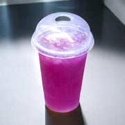 Limonada violeta de flor de guisante mariposa en vaso para llevar a contraluz