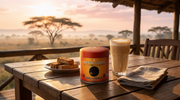 Lata de Vanilla Rooibos Powder de Matcha Colors en una mesa de lodge al amanecer en la sabana con latte cremoso y bizcochos - campaña IA
